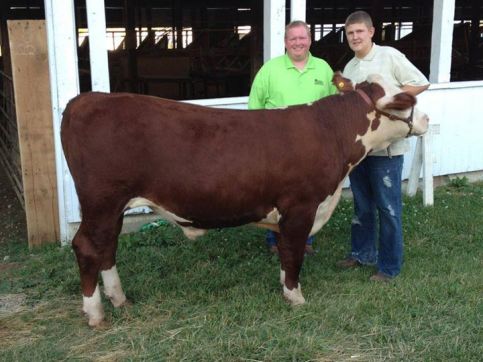 Marion County Farm Bureau President, Mike Honeycutt, pictured with a Marion County 4-H youth and his livestock project, which was donated to Second Helpings.